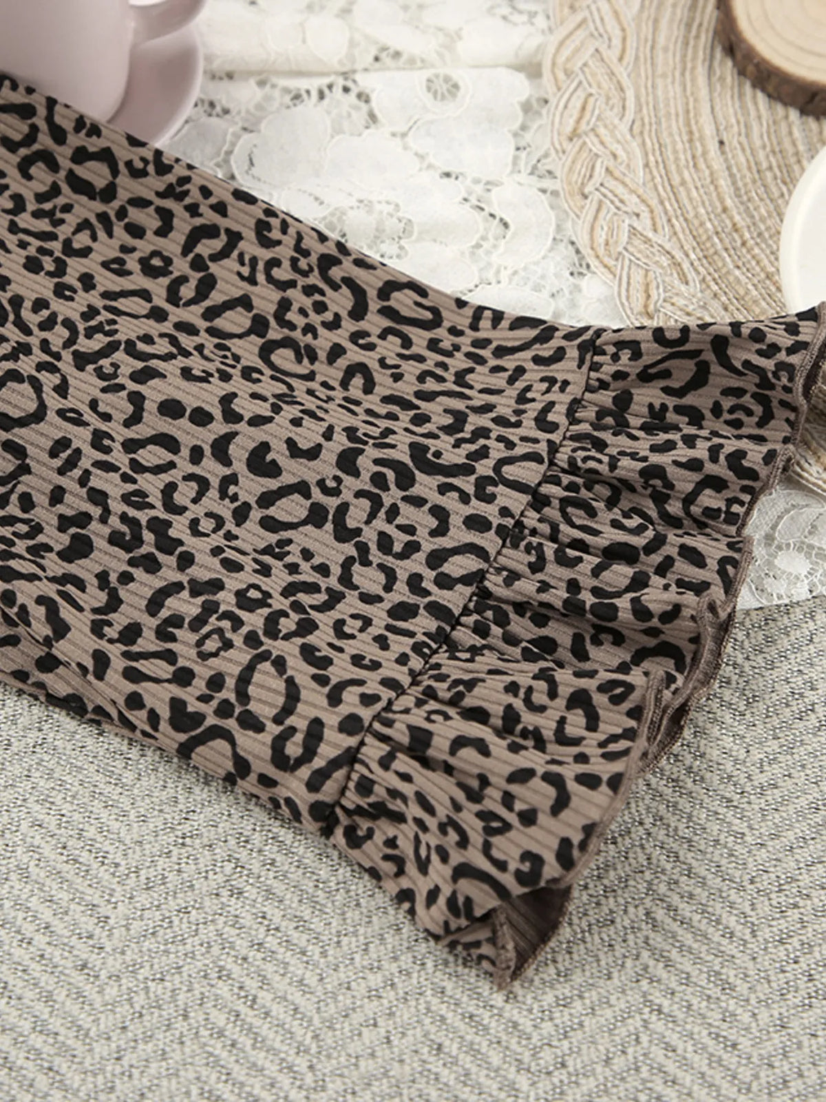 Leopard-print cardigan shown from the back on mannequin