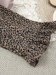 Leopard-print cardigan shown from the back on mannequin