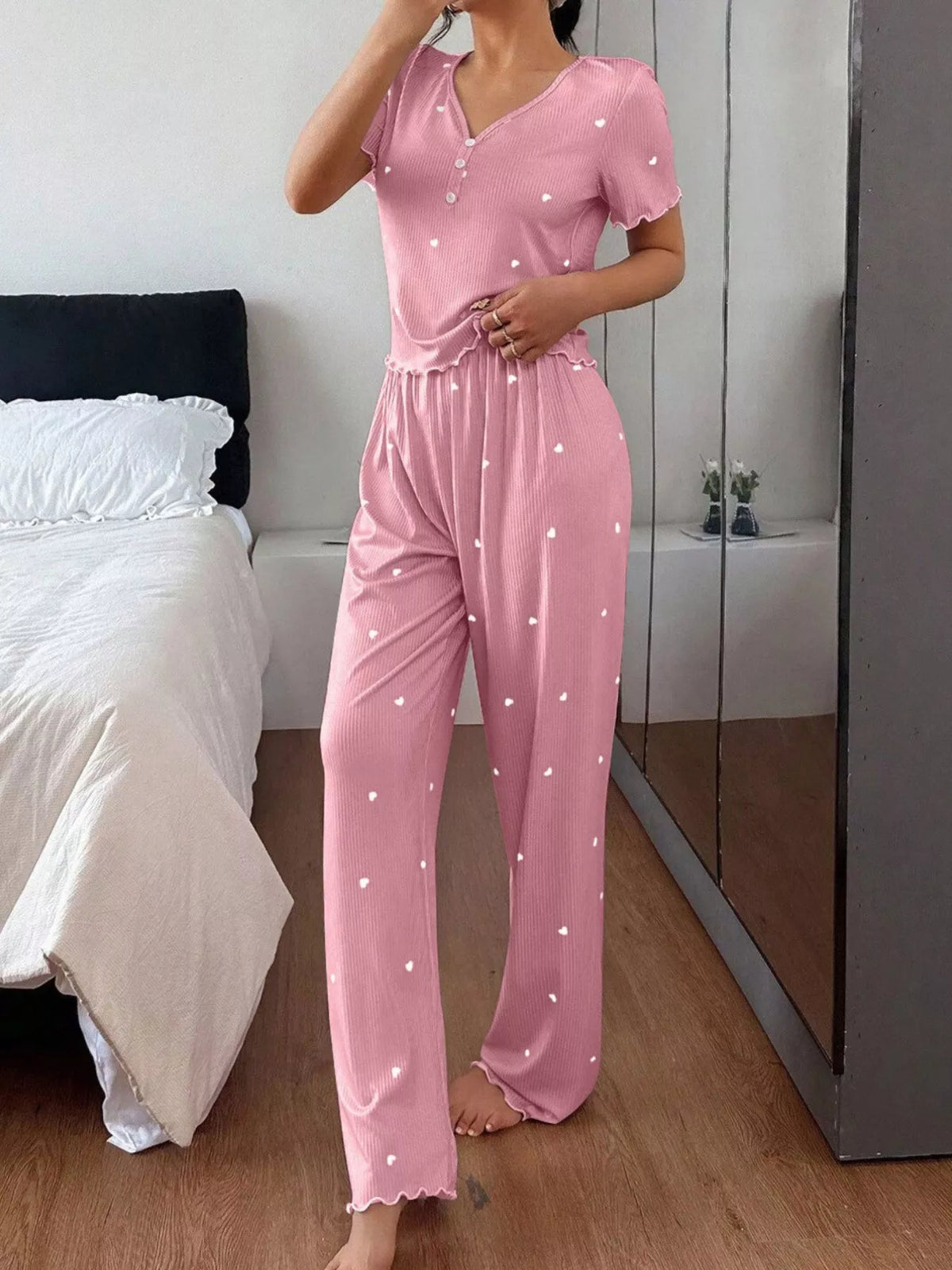 Model wearing pink heart-print short-sleeve top and pants with lettuce trim
