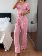 Model wearing pink heart-print short-sleeve top and pants with lettuce trim