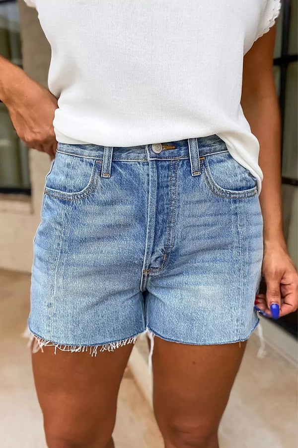 Front view of light-wash high-waisted denim shorts with frayed hems