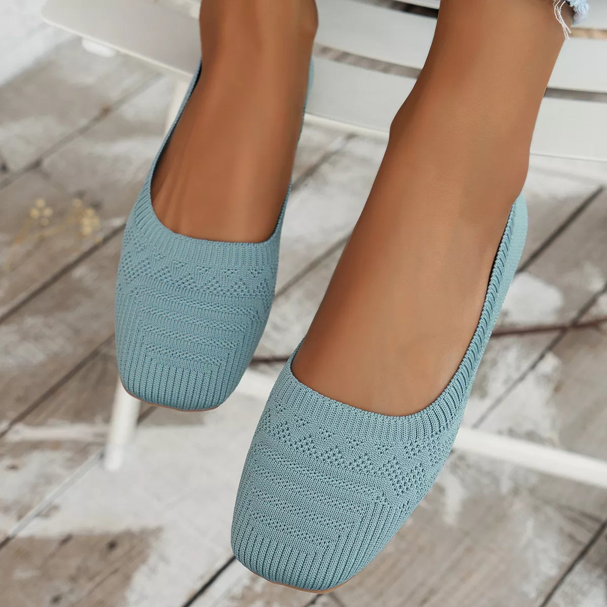 Sky blue mesh flats worn from the front