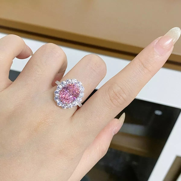 Blush pink oval zircon ring worn on a hand.