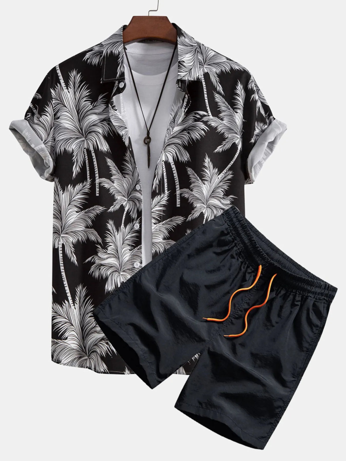 Black short-sleeve button-front shirt and shorts with white palm tree print