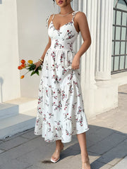 White rose-print midi dress with tiered skirt and V-neck bodice, styled with tulips