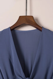 Close-up of V neckline on blue dress