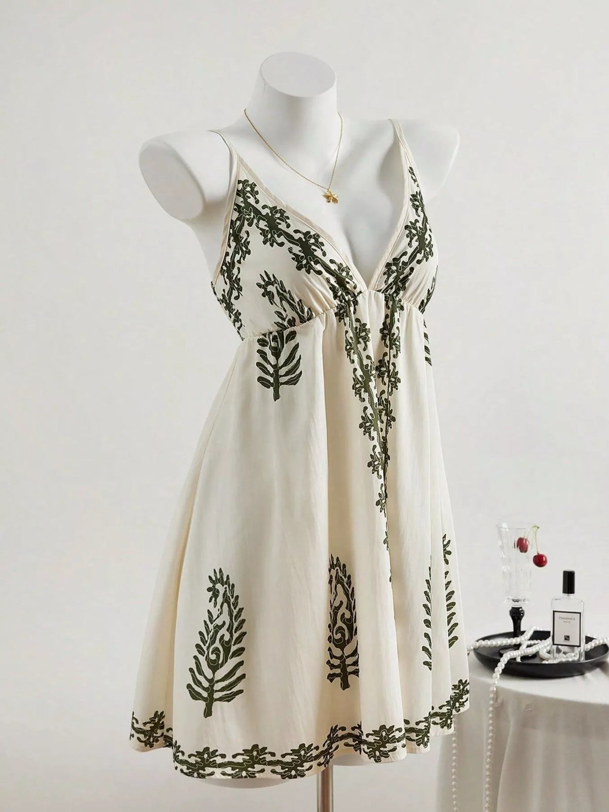 Front view of embroidered ivory sleeveless dress on mannequin