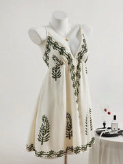 Front view of embroidered ivory sleeveless dress on mannequin