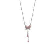 Silver butterfly pendant necklace with dangling stones shown on white