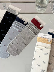 Blue, cream, gray and black printed socks displayed together