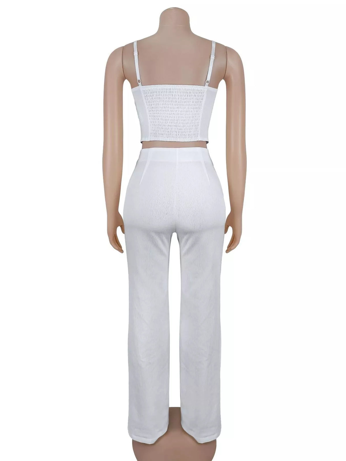 White cami and wide-leg pants set displayed from the back on a mannequin.
