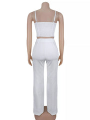 White cami and wide-leg pants set displayed from the back on a mannequin.
