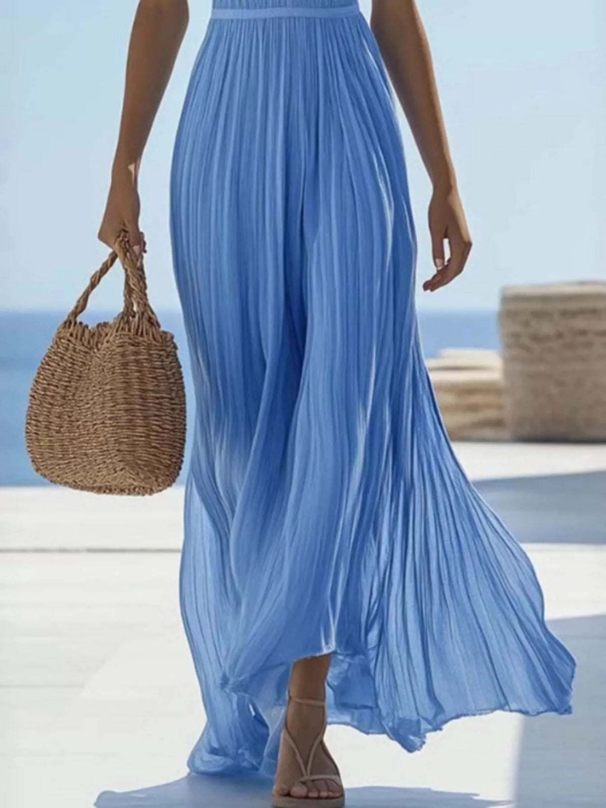 Full-length view of sky-blue pleated maxi dress with flowing skirt