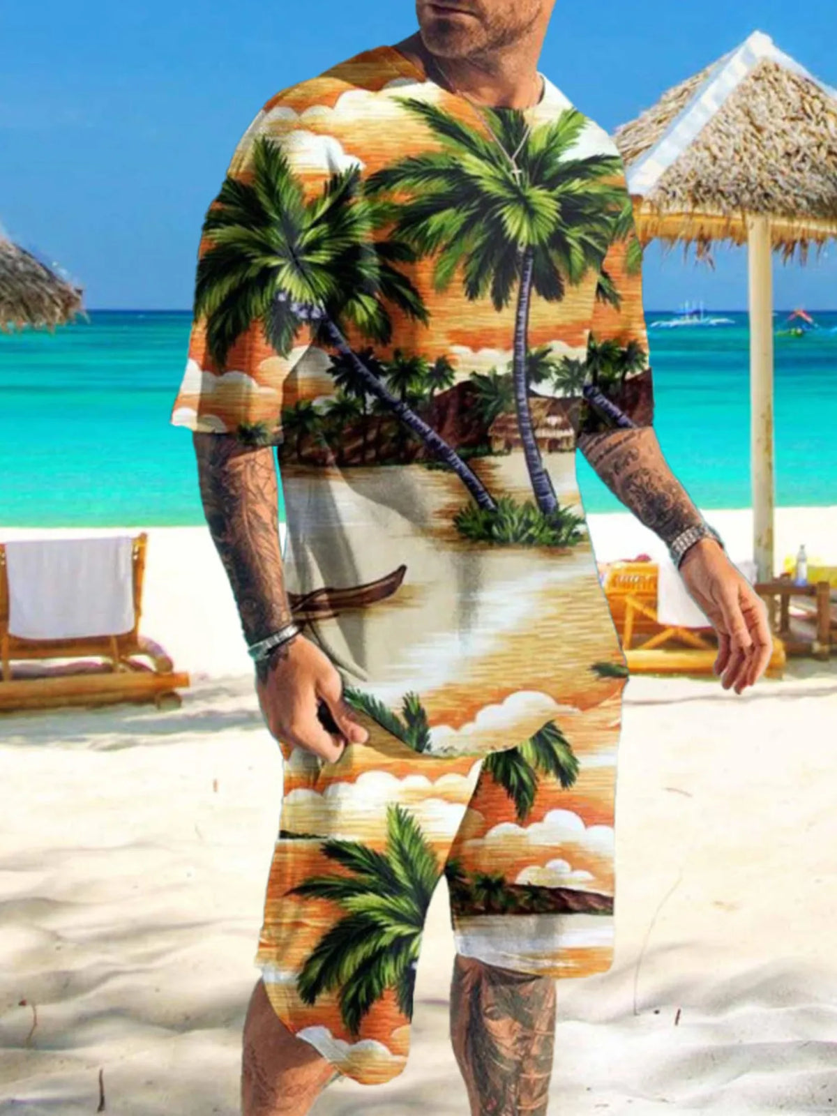 Man wearing orange, green and cream palm tree print shirt and shorts on a beach