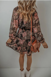 Back view of dark floral mini dress with long sleeves