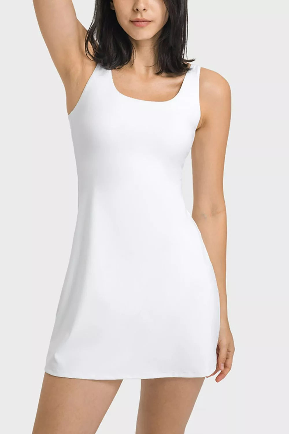 Front view of a white square-neck sports dress with wide shoulder straps.