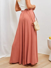 Model wearing rose wide-leg pants with a white top