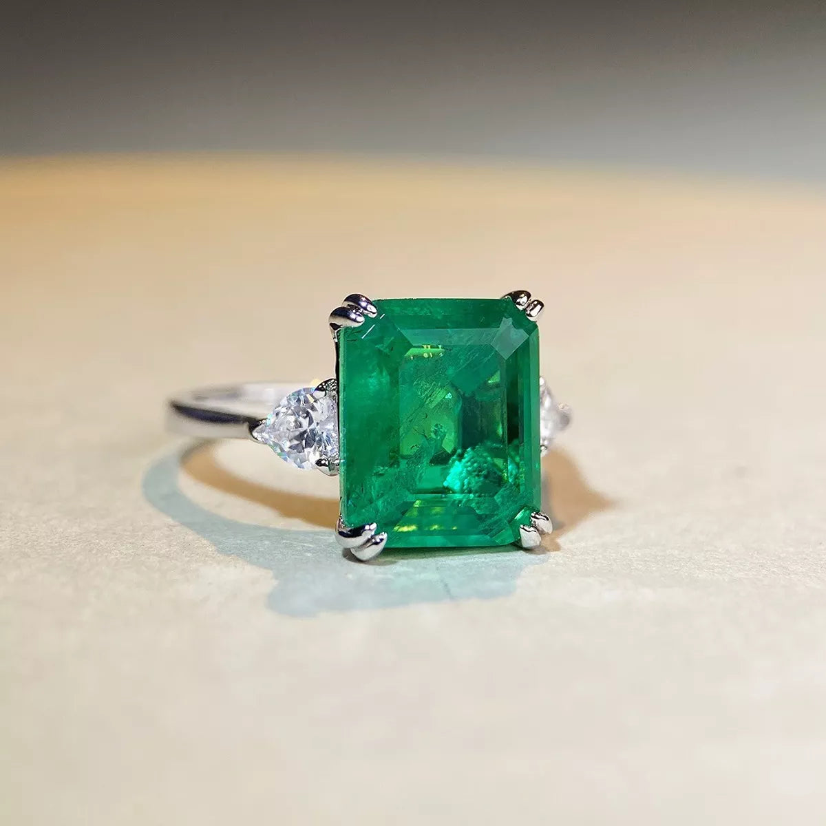 Green centre stone zircon ring shown at an angle.