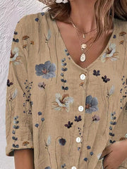 Detail of beige floral blouse neckline and buttons.