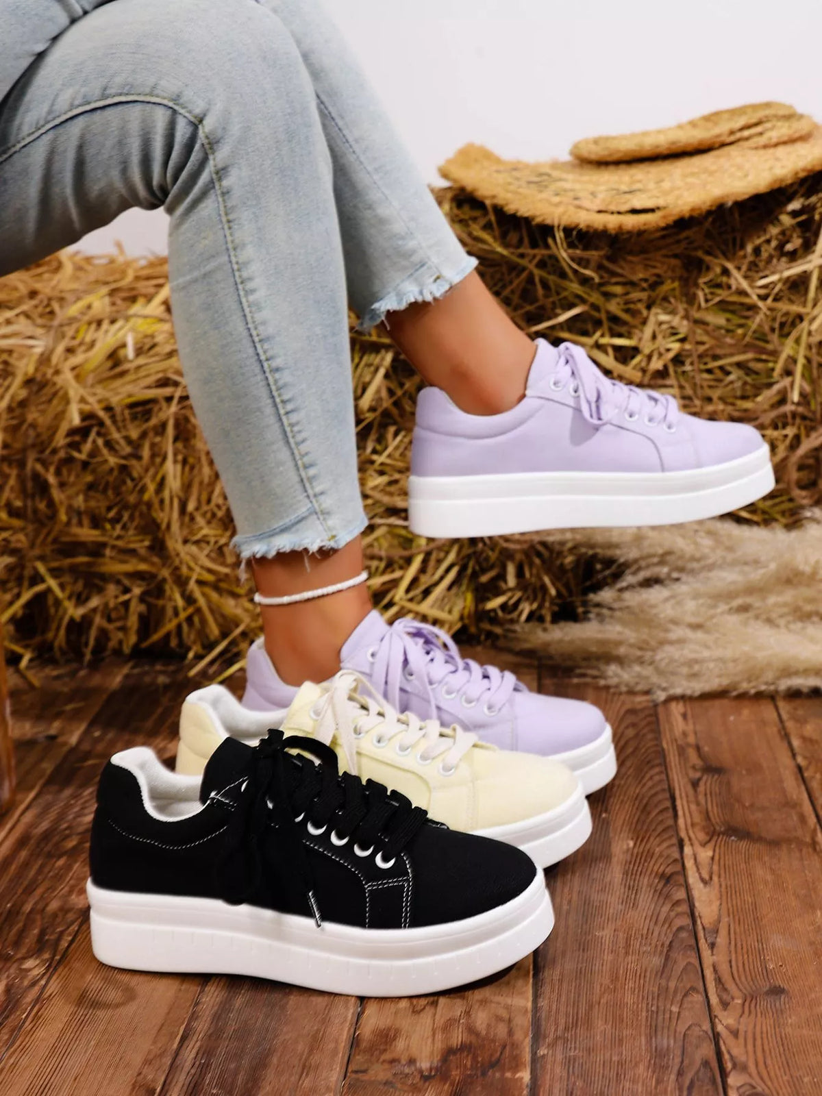 Lavender and black lace-up platform sneakers shown together