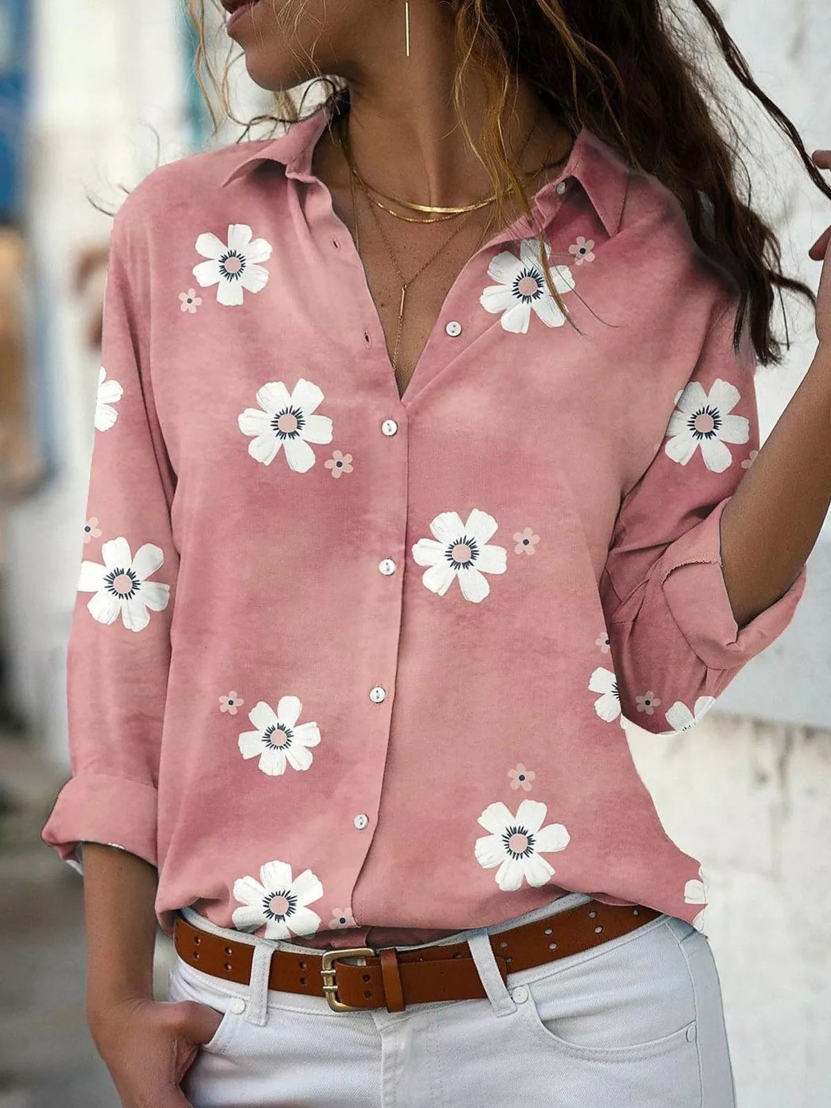 Pink floral button-down shirt with rolled sleeves, front view on a model.