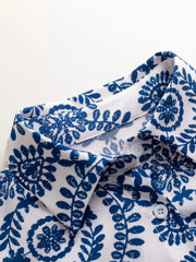 Women's printed tie-waist button-front romper, close-up of button-front neckline