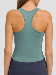 Back view of teal racerback tank with wide arm openings