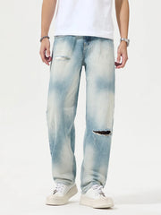 Light-wash distressed relaxed jeans shown from the front