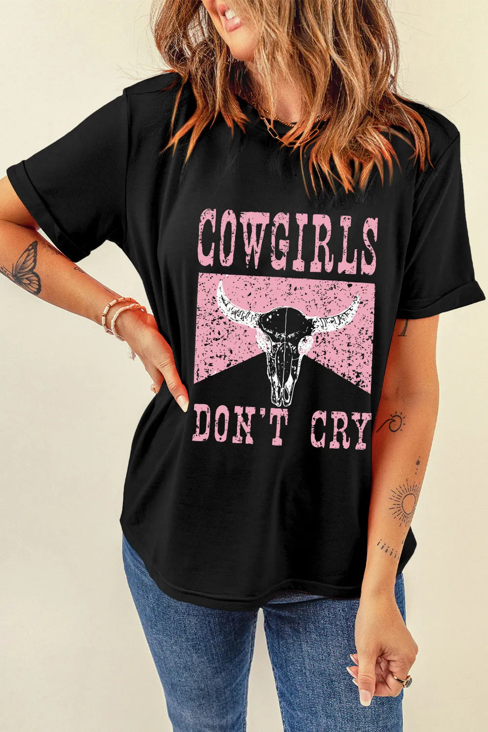 Model wearing black western graphic T-shirt with hand on hip