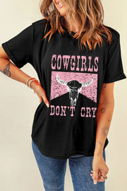 Model wearing black western graphic T-shirt with hand on hip