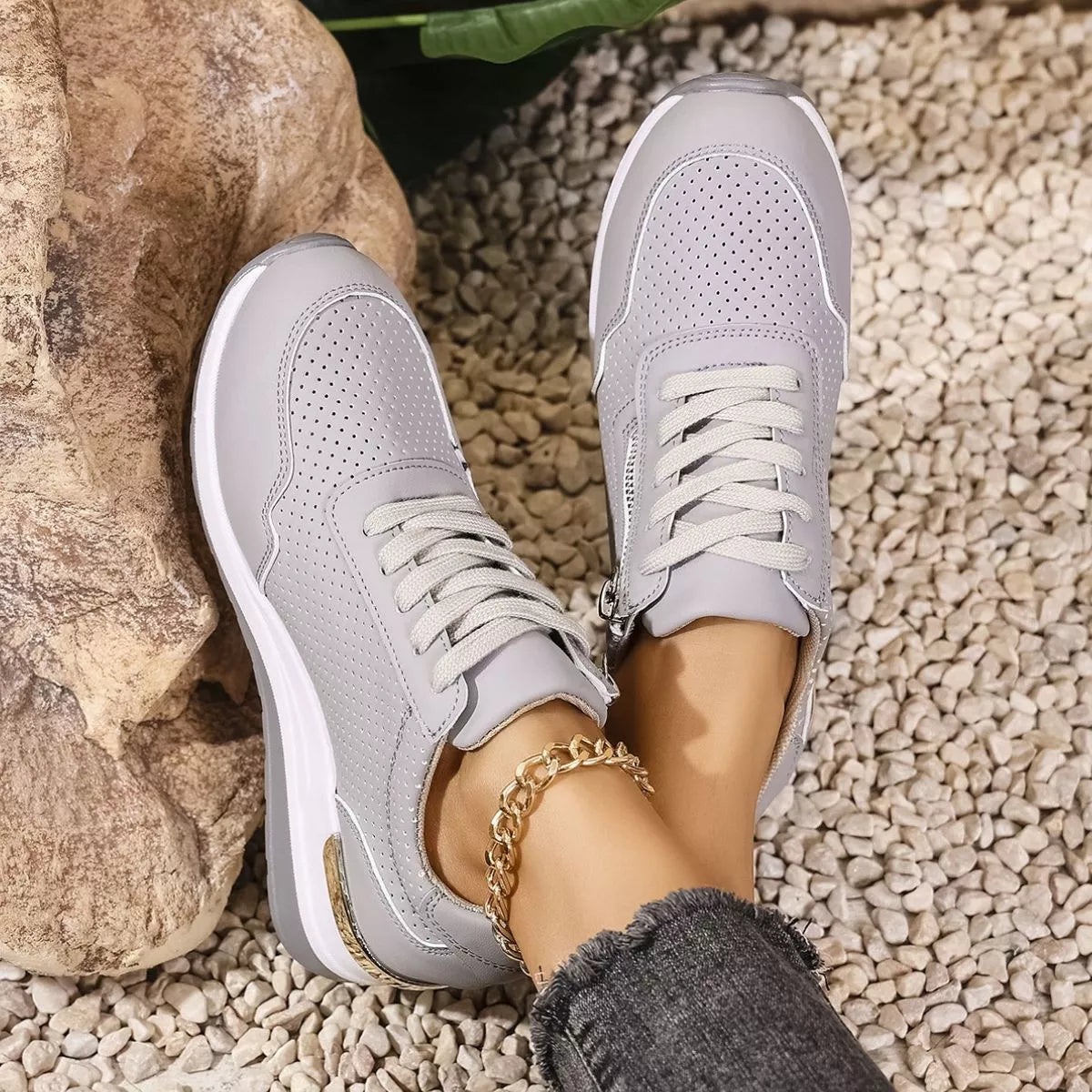 Top view of gray lace-up knit sneakers with white soles