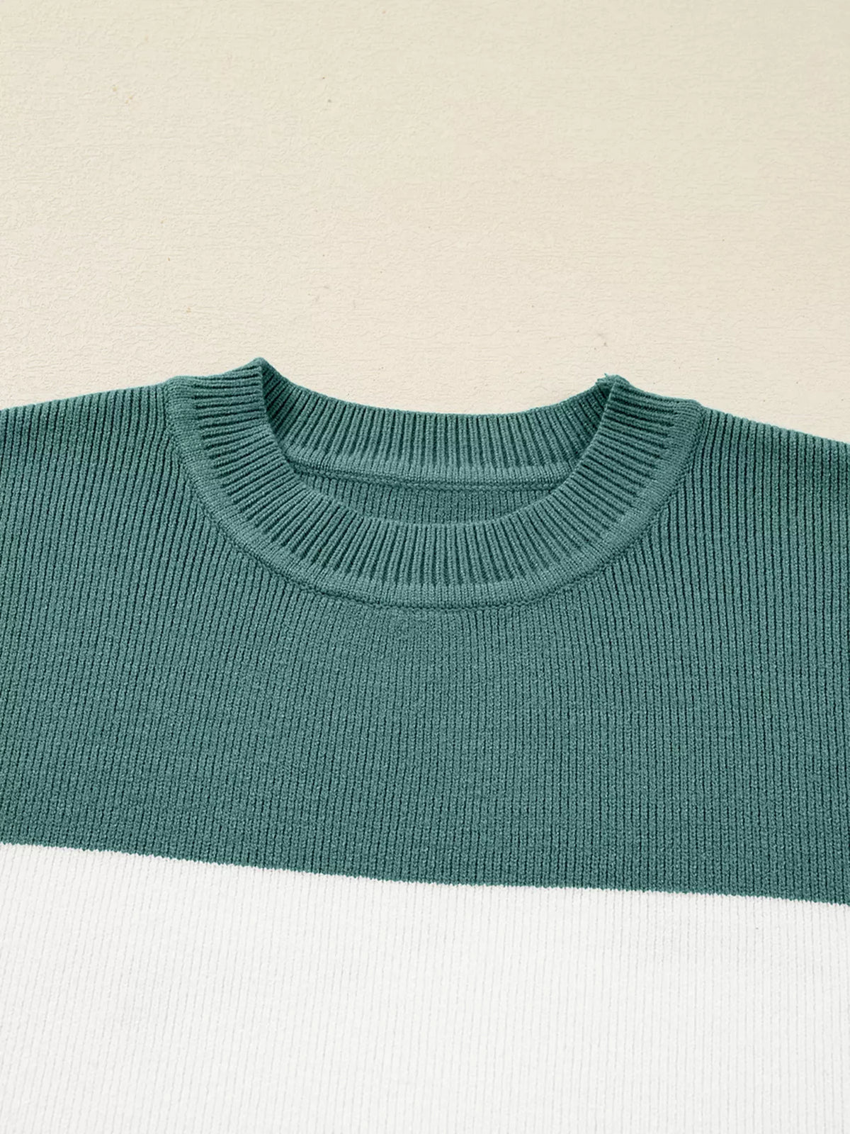 Close-up of teal ribbed crew neckline