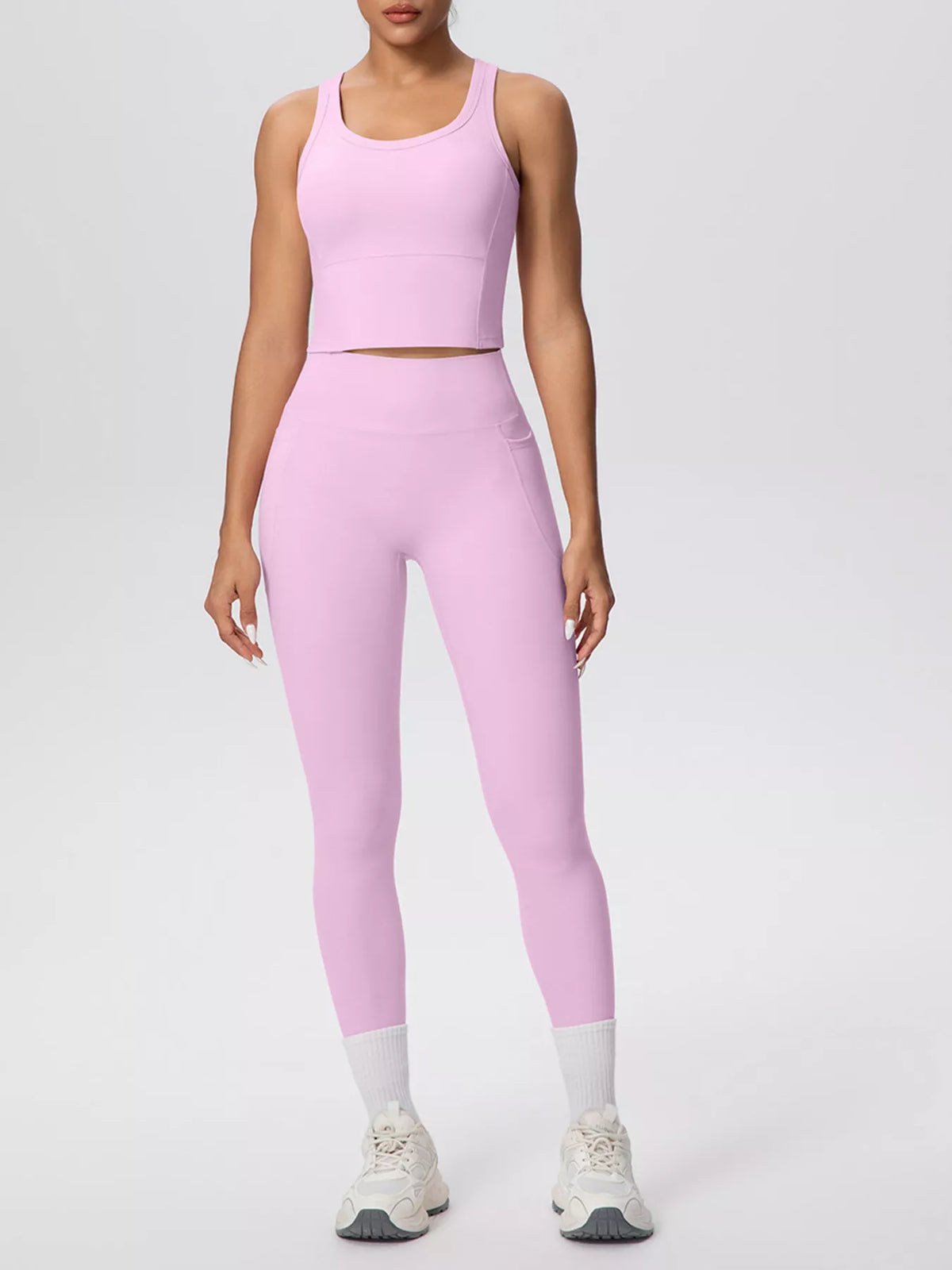 White activewear set shown from the side with a phone in pocket