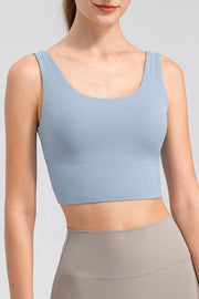 Light blue cropped tank worn with taupe leggings, front view