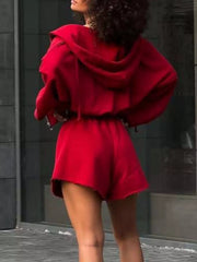 Model wearing taupe zip hoodie and matching shorts over a white top