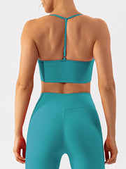 Back view of teal active bra with adjustable center strap