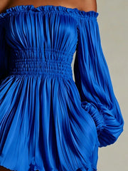 Closer view of blue dress showing pleated bodice and gathered waist