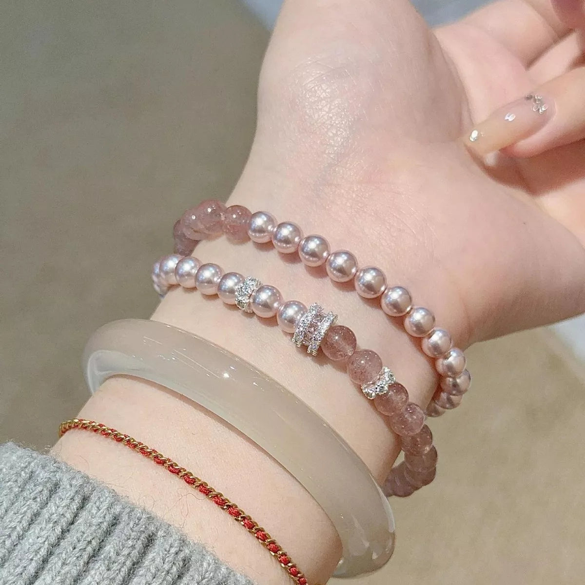 Two pearl bracelets worn stacked on the wrist