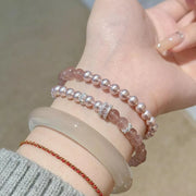 Two pearl bracelets worn stacked on the wrist