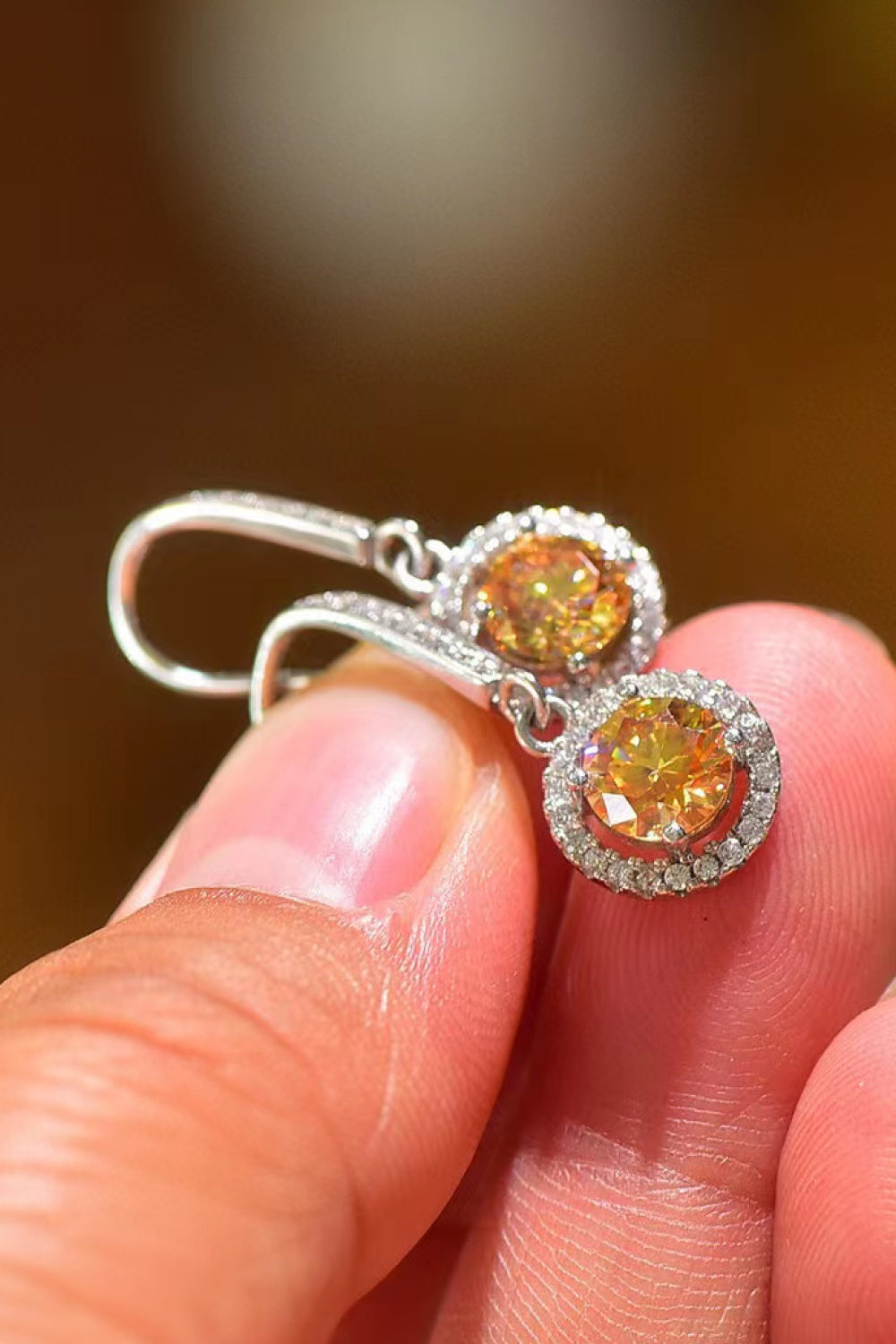 Platinum-Plated 2 Carat Moissanite Drop Earrings — Close-up of moissanite drop earrings held in hand