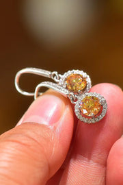 Platinum-Plated 2 Carat Moissanite Drop Earrings — Close-up of moissanite drop earrings held in hand