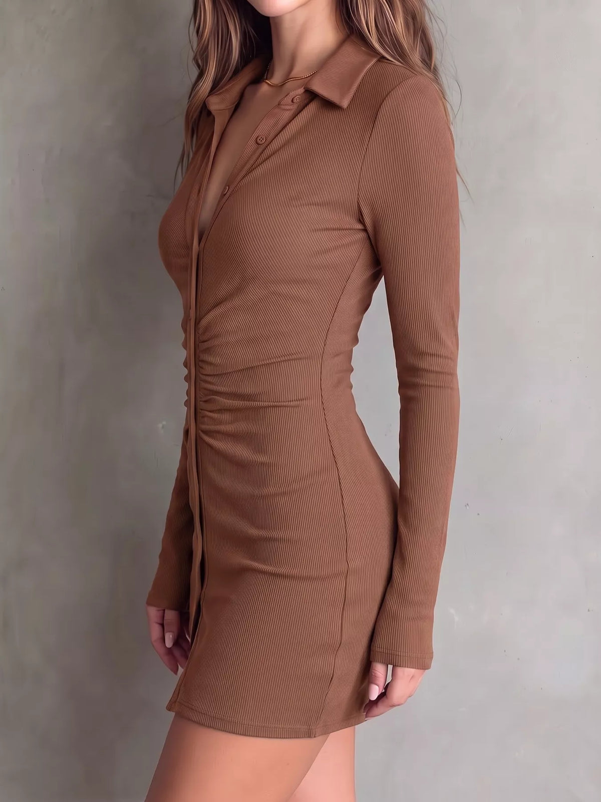 Side view of brown button-front dress with close-fitting silhouette.
