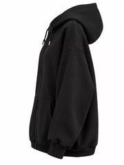 Side view of the black hoodie showing its hood profile and roomy sleeve