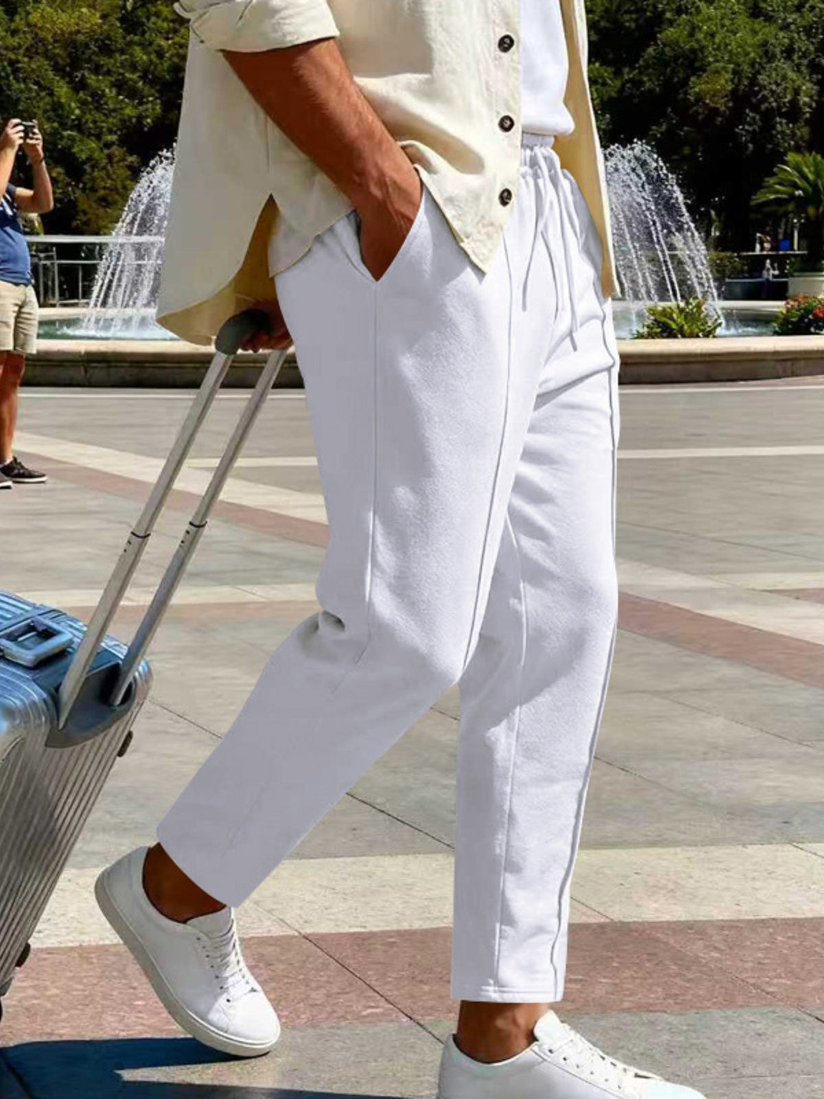 Front view of cream pants with drawstring waist near the Statue of Liberty.