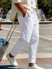 Front view of cream pants with drawstring waist near the Statue of Liberty.