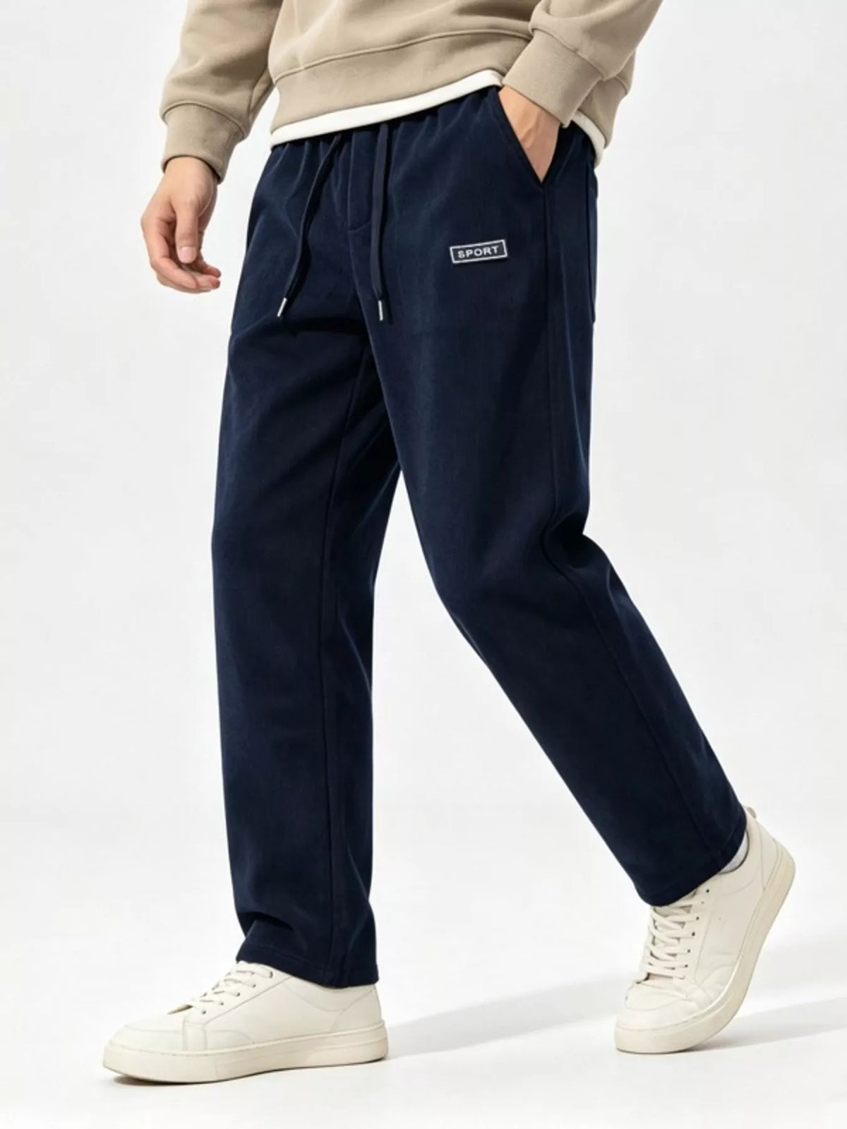 Model walking in navy wide-leg pants showing the loose straight legs and side pocket