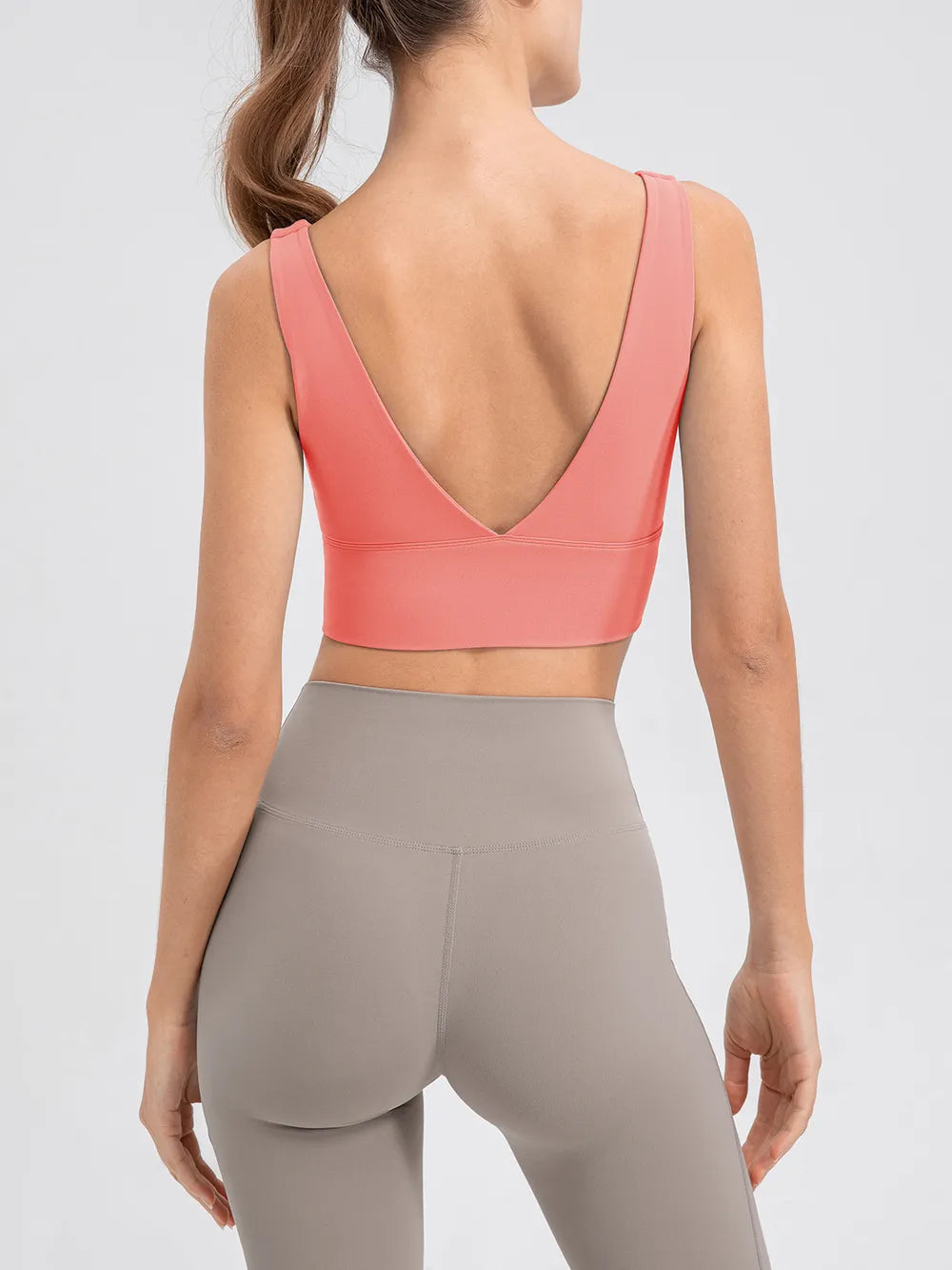 Back view of the pink tank showing its deep V-back