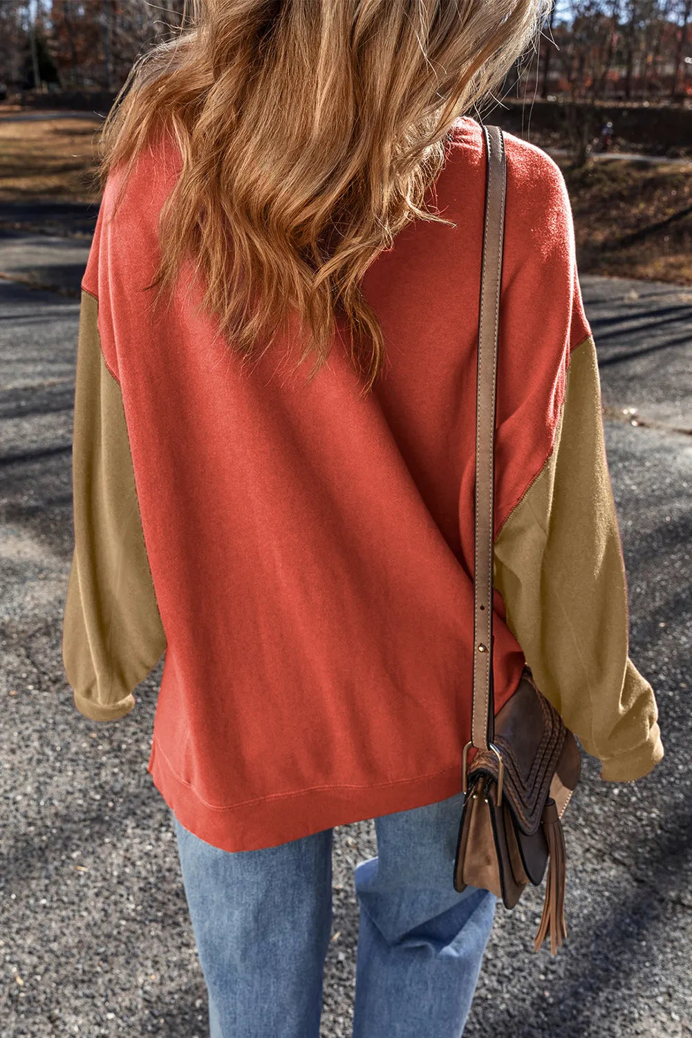 Back view of rust sweatshirt with tan sleeves