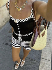 Black striped knit shorts styled with handbag and sneakers