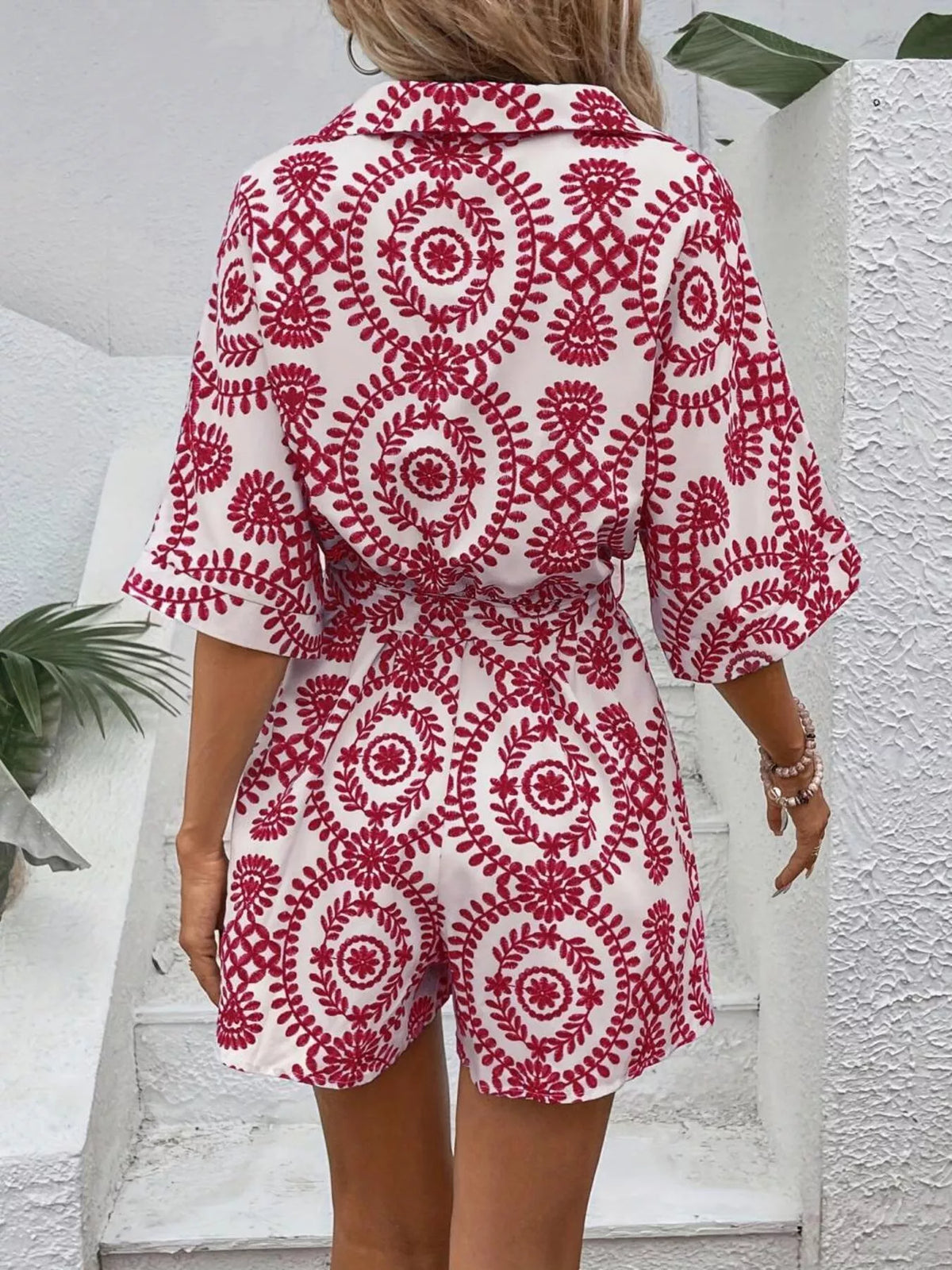 Women's printed tie-waist button-front romper, close-up of red print